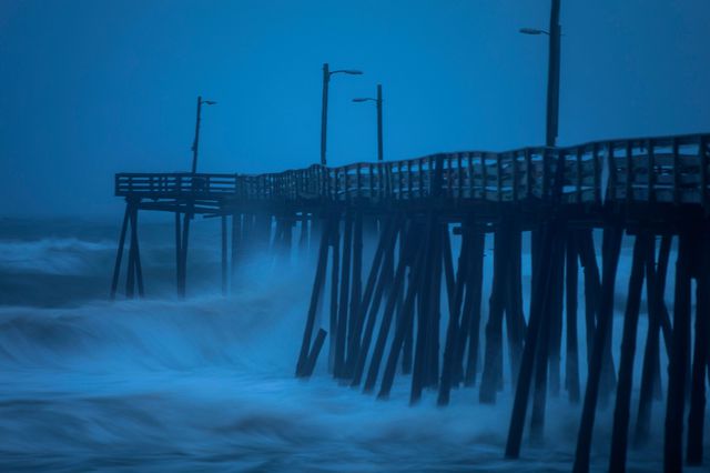 Strong waves crashing against a fishing pier on Friday, September 6, 2019.